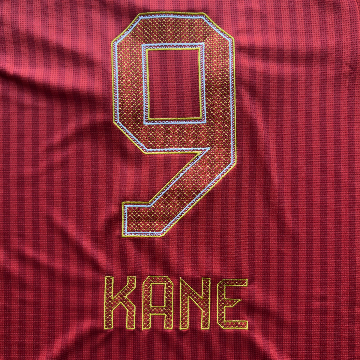Detail of Kane's 9 and nameset embroidered in gold on the Bayern Munich home jersey