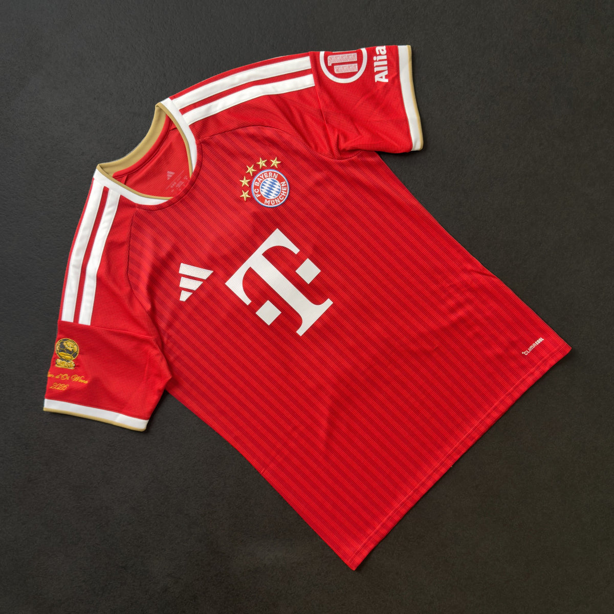 Front of the Bayern Munich home jersey with the gold Ballon d'Or sleeve patch