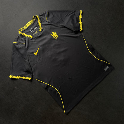 Front of the black Chelsea away jersey with yellow trim and Nike swoosh