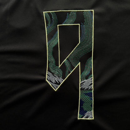 Haaland 9 embroidered with green and blue Northern Lights over grey mountains, outlined in pale yellow