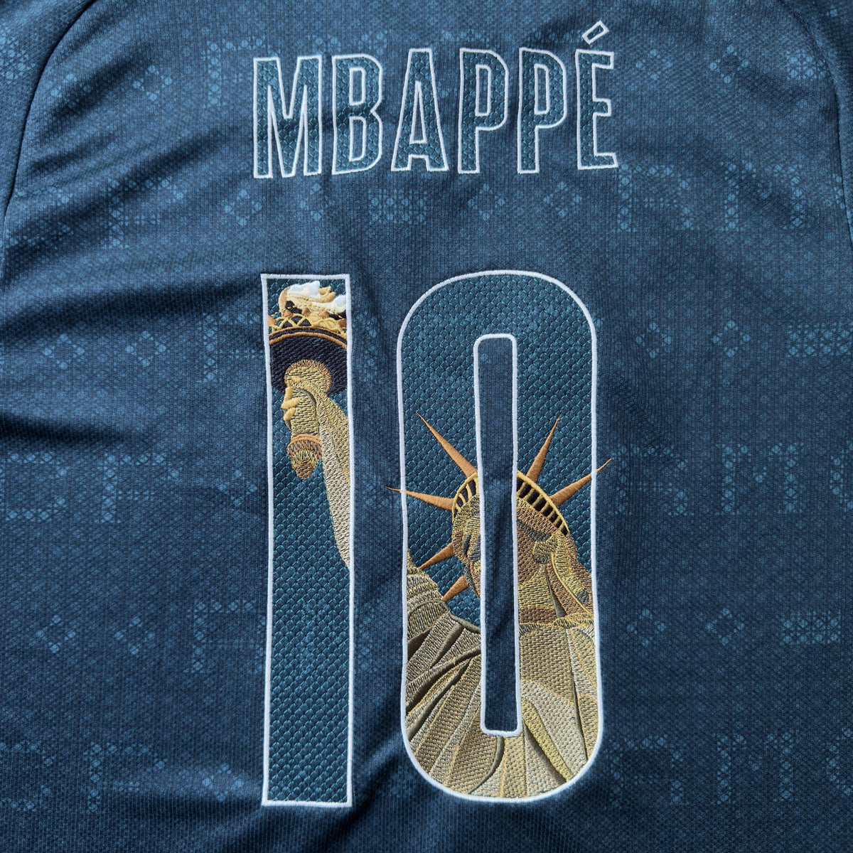 MBAPPÉ name and 10 embroidered with the Statue of Liberty, her torch in the 1 and crown in the 0