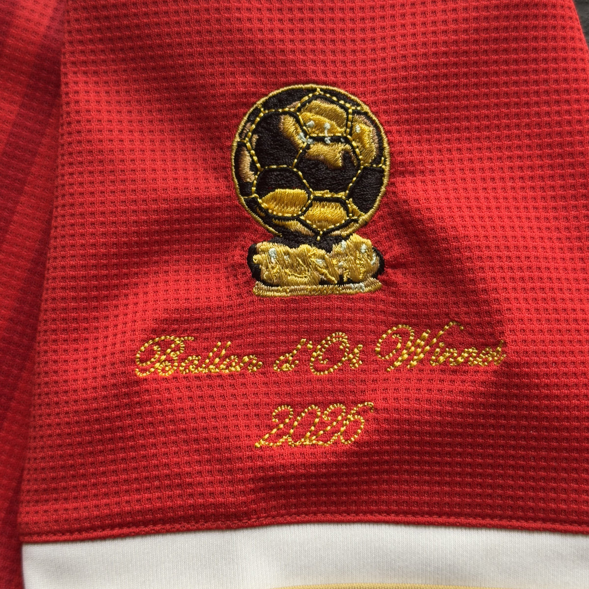 Close-up of the embroidered gold Ballon d'Or trophy patch with Ballon d'Or Winner 2026 in script