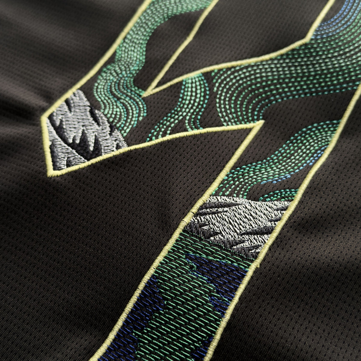 Close-up of the aurora running stitch and satin-stitched mountains on the Haaland 9