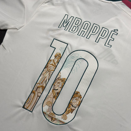 Angled view of the Mbappé 10 on the Real Madrid home jersey, with the Cibeles Fountain embroidered through the numbers