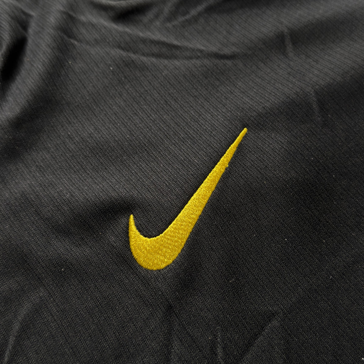 Yellow Nike swoosh on the front of the Chelsea away jersey