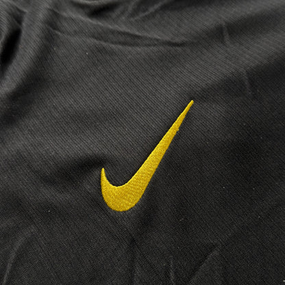 Yellow Nike swoosh on the front of the Chelsea away jersey