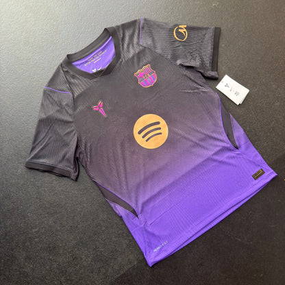 Front of the genuine Nike Barcelona 26/27 away jersey, a black to purple fade with the Mamba logo on the chest