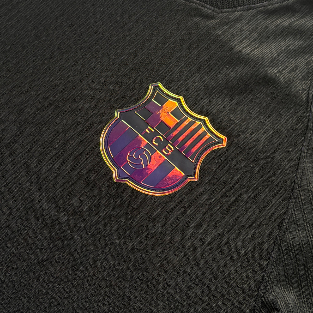 Iridescent Barcelona crest on the front of the away jersey
